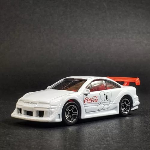 White diecast model car with Coca-Cola graphics, front 3/4 view