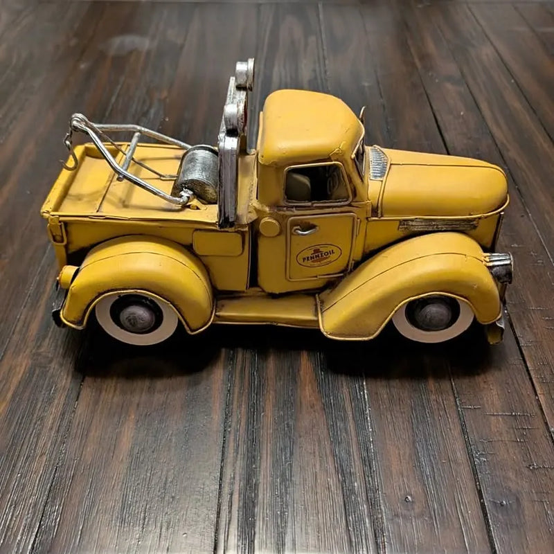 Yellow diecast tow truck with Pennzoil logo, open cab and front grille detail
