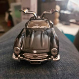 Black 1:36 scale diecast pull-back car, front view with chrome bumper