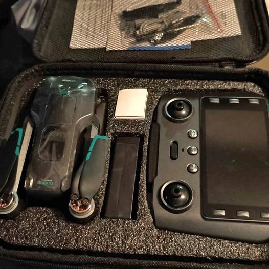 Drone parts in hard carrying case, with controller and prop guards