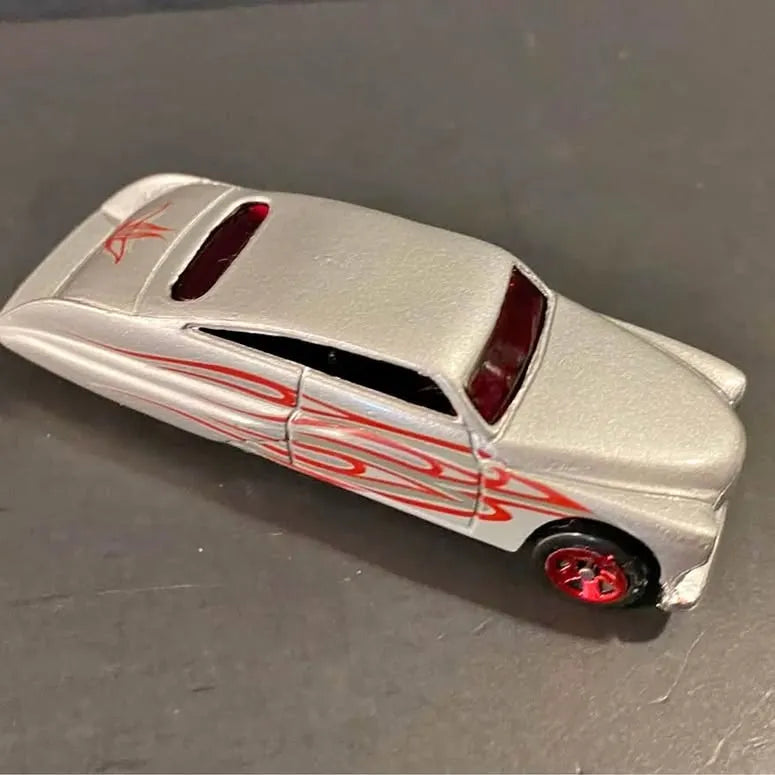 Grey diecast lowrider car with red flame graphics, red wheels