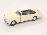 Cream convertible diecast model car with whitewall tires and chrome grille