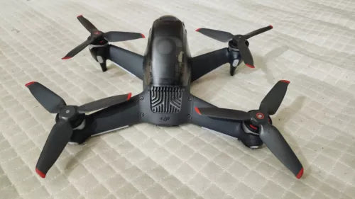 DJI FPV drone aircraft with four dark propellers and black body