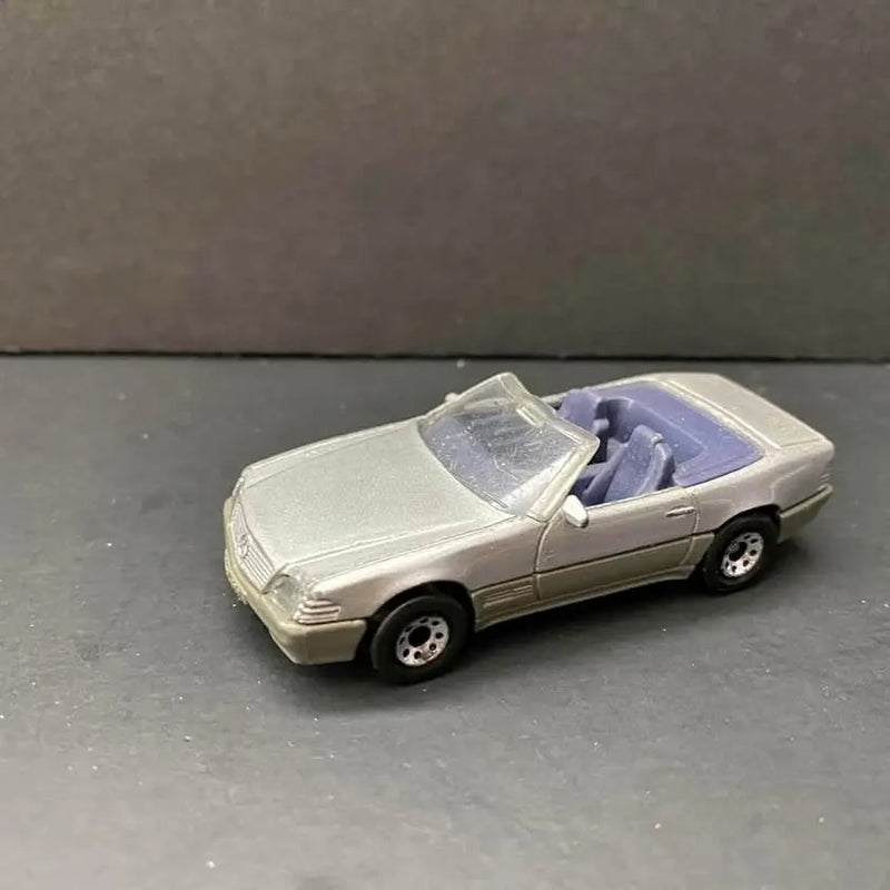 Silver convertible diecast car model with open top and detailed wheels