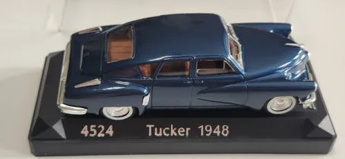 Blue Tucker 1948 diecast model car in black acrylic display case, base reads 4524 Tucker 1948