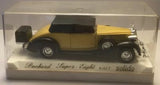 Yellow classic Packard Super Eight diecast model car in a clear display case