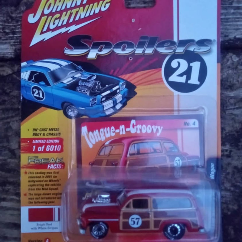 Red die-cast woody wagon model car with black wheels, in blister packaging.