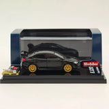 Black diecast model car with gold wheels, displayed in clear case on stand
