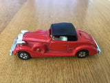 Red diecast car with black soft top and side doors, 1/72 scale