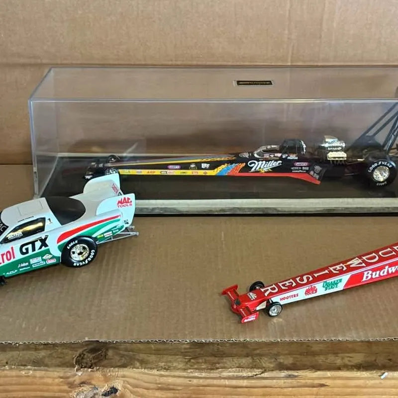 1/24 scale NHRA diecast drag car set in display case, three colorful cars