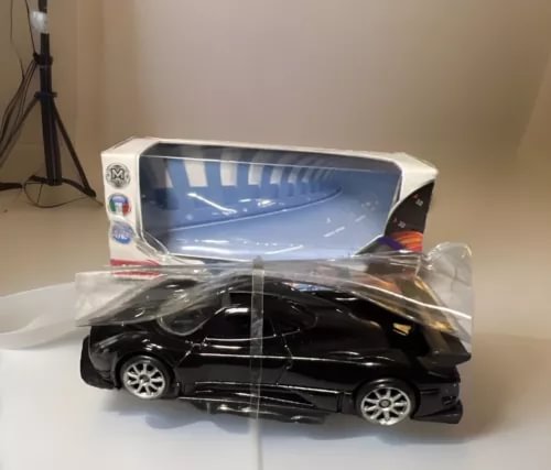 1/64 scale black diecast sports car in clear packaging, with box tray