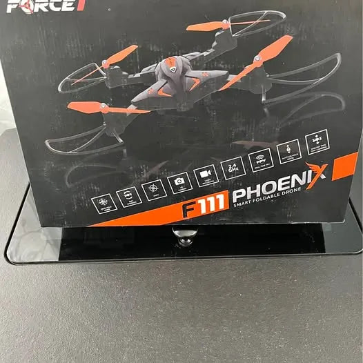 Foldable quadcopter drone in retail box, orange and gray with folding prop arms.