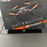 Foldable quadcopter drone in retail box, orange and gray with folding prop arms.