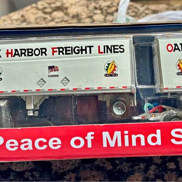 Diecast Oak Harbor Freight Lines trailer replica side with logo and railing detail