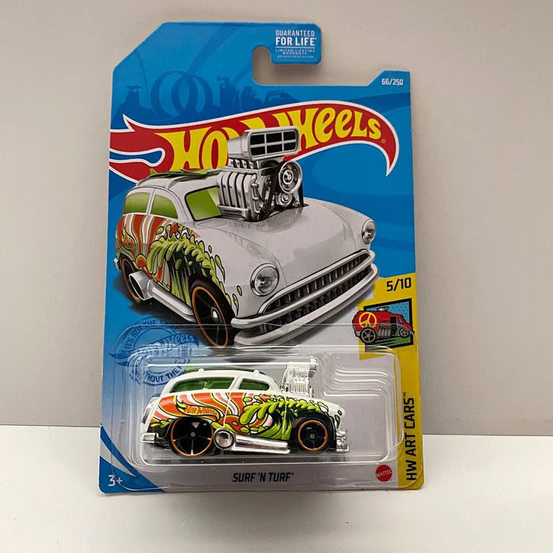 Die-cast toy car in blister pack with white and green hot rod graphics