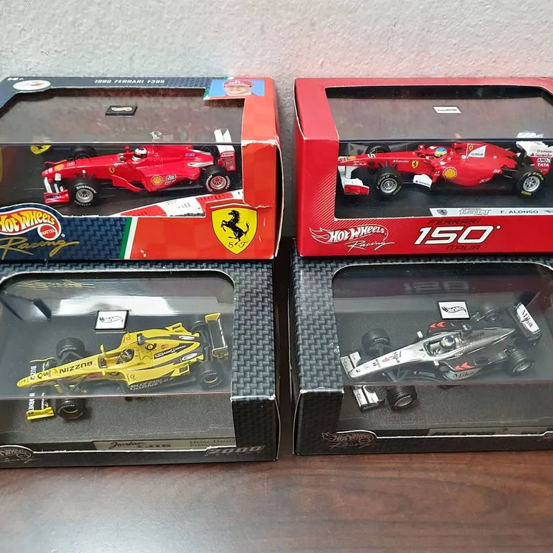1/43 Formula 1 diecast cars, red and yellow in retail display boxes