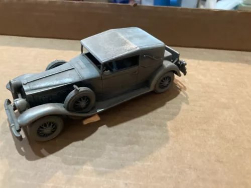 Pewter diecast convertible car, front view with open top and black tires