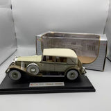 Tan brown 1/18 diecast classic model car with white roof on display base