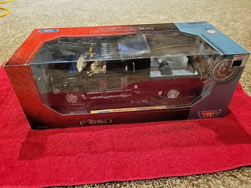 Diecast pickup truck model in retail box, clear window and red body