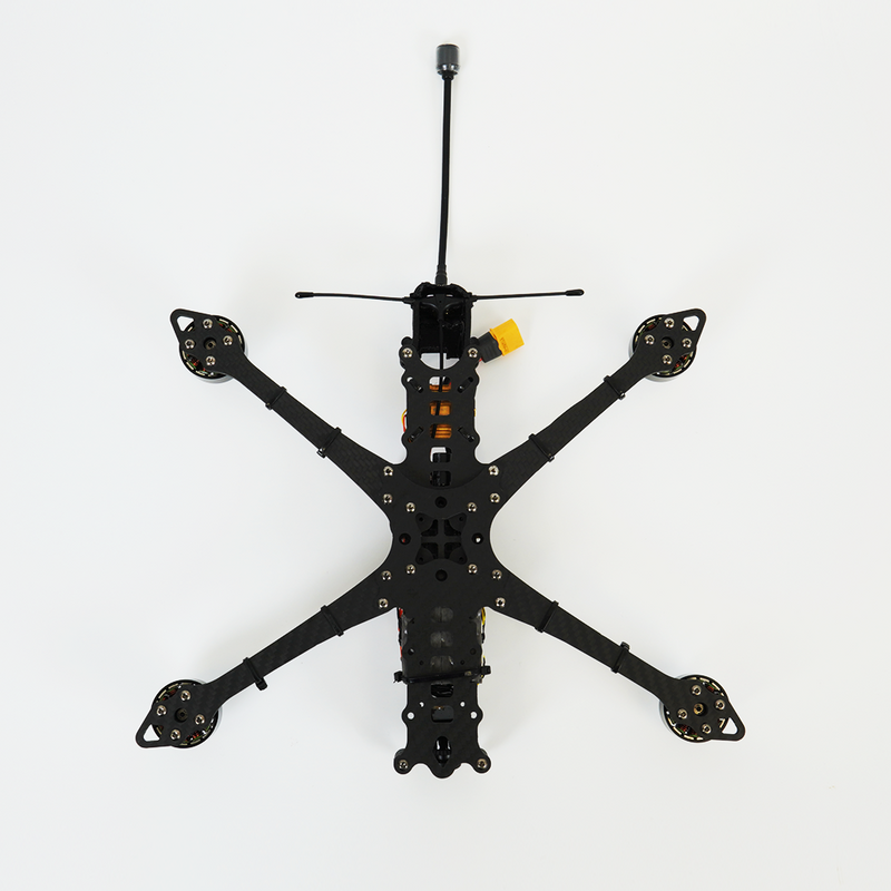 Black quadcopter drone with four arms and central camera housing