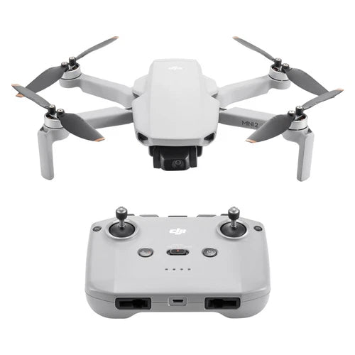 Foldable white DJI Mini 2 SE drone with propellers and controller base