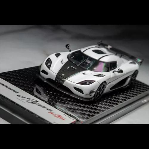 White and black carbon diecast sports car model with visible cockpit interior, front 3/4