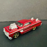 Hot Wheels red 1964 Chevy Impala diecast car with open hood and chrome engine detail