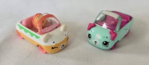 Mini diecast cars in bakery-themed designs, two toy cars with character faces