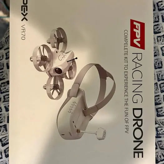 White racing drone with four propellers and compact foldable arms