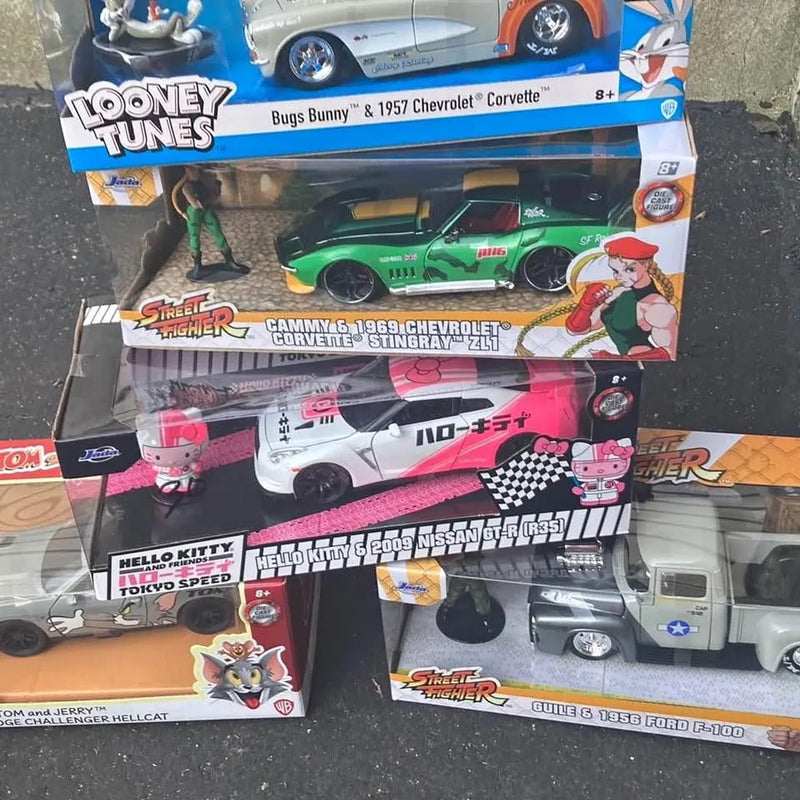 Diecast car collection in retail box display with multiple cartoon-themed vehicles