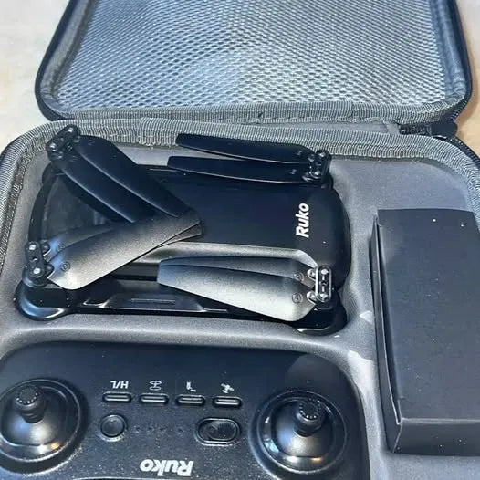 Ruko flying drone with propellers and controller panel in storage case