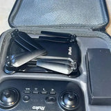 Ruko flying drone with propellers and controller panel in storage case