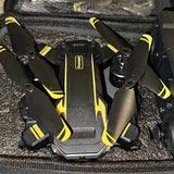 Black drone with yellow accents, front camera module and foldable landing legs