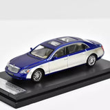 Two-tone blue and white diecast model car on display base, 1/64 scale