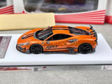 Orange racing sports diecast car model with black wheels and rear spoiler