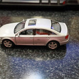 Silver diecast sedan model with tinted windows and chrome wheels