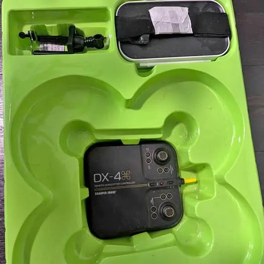 Compact drone with remote control inside green molded carrying case