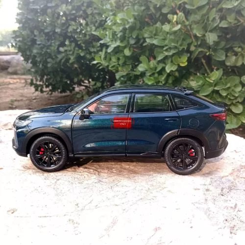 Teal blue 1:18 SUV diecast model with black wheels and red tail lights, side view
