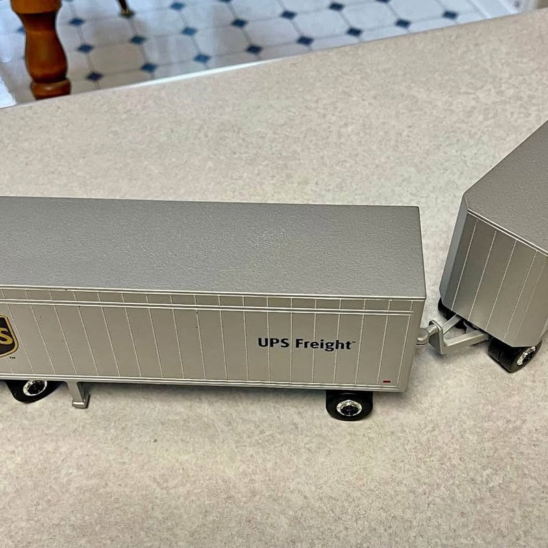 Diecast UPS Freight trailer replica with silver wheels, side view