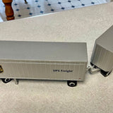 Diecast UPS Freight trailer replica with silver wheels, side view