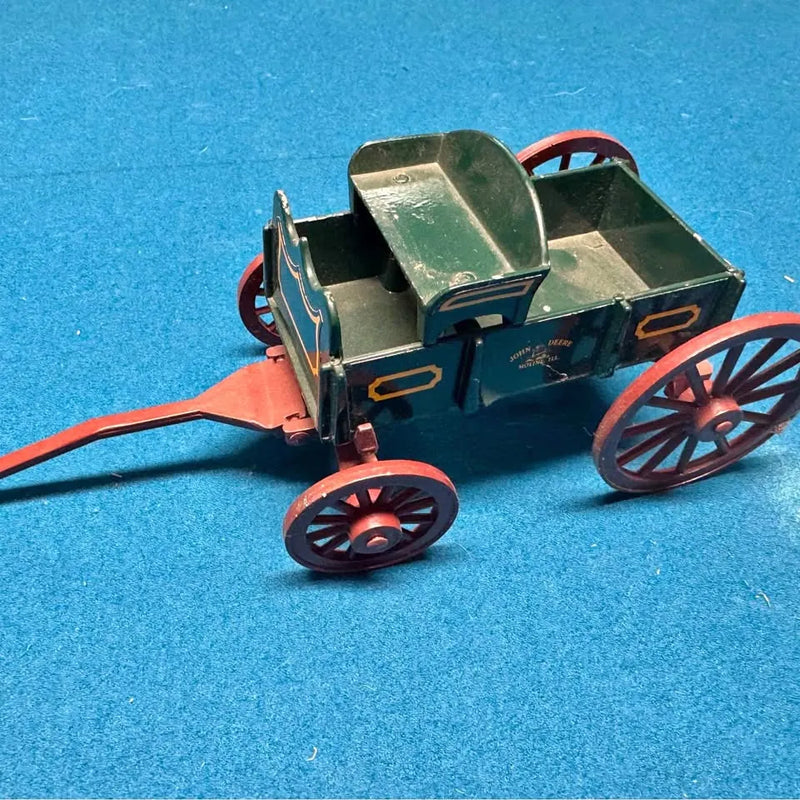 Diecast wagon with green cab, dark blue body, red spoked wheels, front left view.