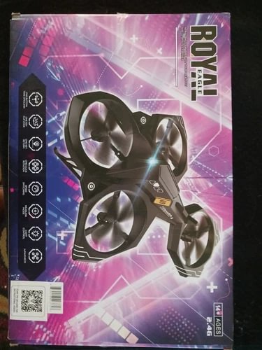 RC quadcopter drone with camera, black frame and four propellers on retail box