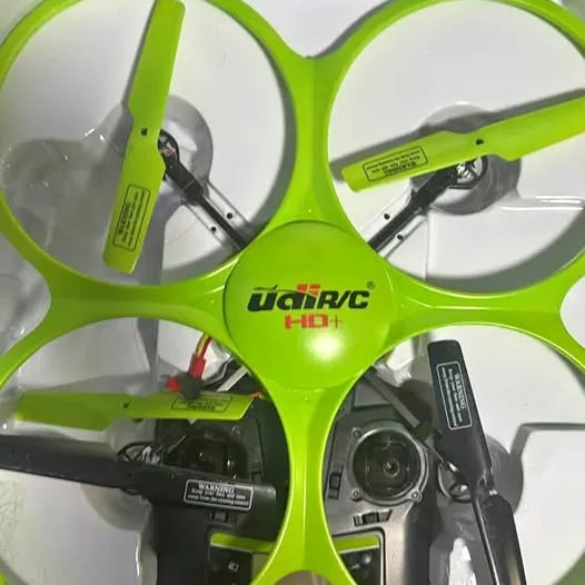 Green quadcopter drone with camera, four propellers and central camera lens