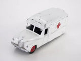 Vintage diecast ambulance toy van, white body with red cross, front/side view.