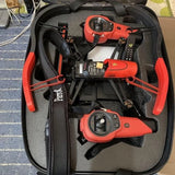 Orange quadcopter drone in hard carrying case with remote controller