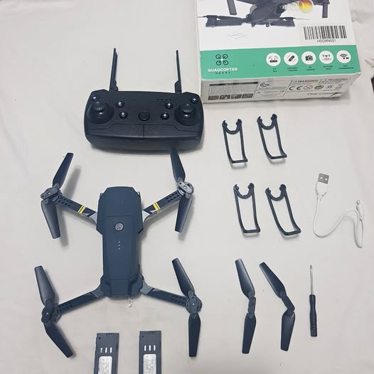 Quadcopter drone kit with remote, propellers, clips, and USB cable