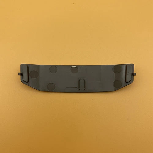 Drone expansion port upper cover, dark gray with circular cutouts and metal latch