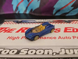 Blue open-top roadster diecast toy car, gold wheels, 1:64 scale, on retail card