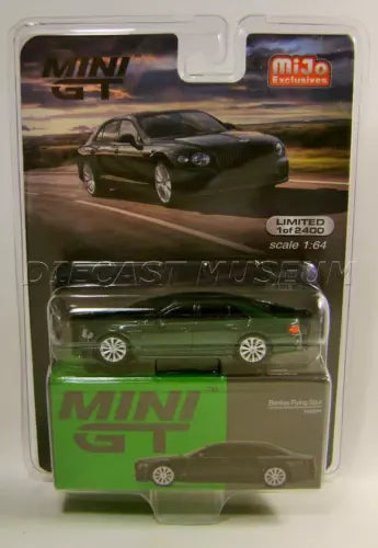 Mini GT die-cast sedan model in blister pack, dark green with silver wheels