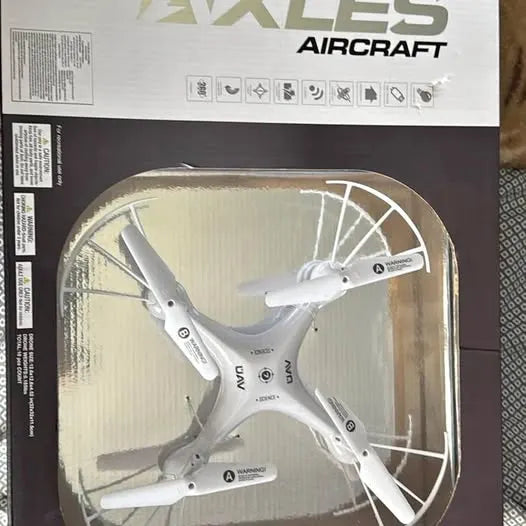 Quadcopter drone with four propellers, in a clear display case
